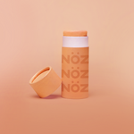 Load image into Gallery viewer, front angle eye level shot Nöz orange color nose application sunscreen stick 
